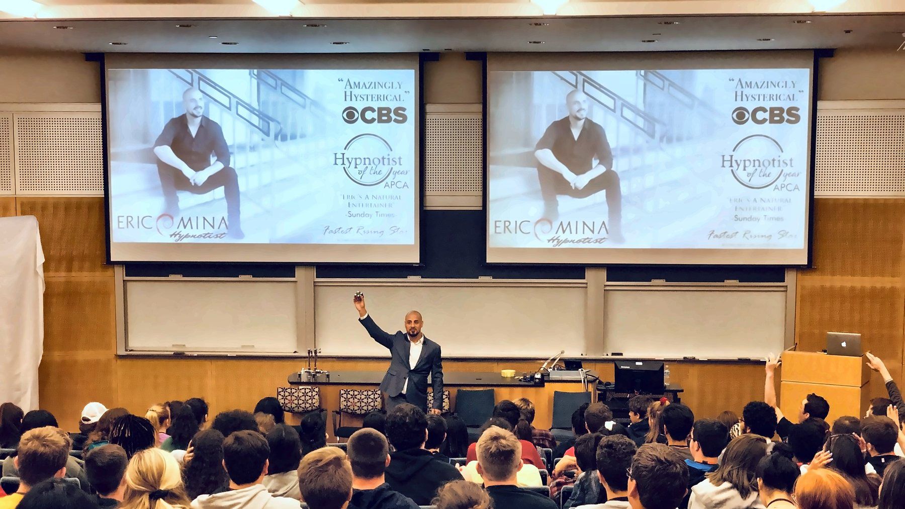 Eric Mina presenting to a packed lecture hall