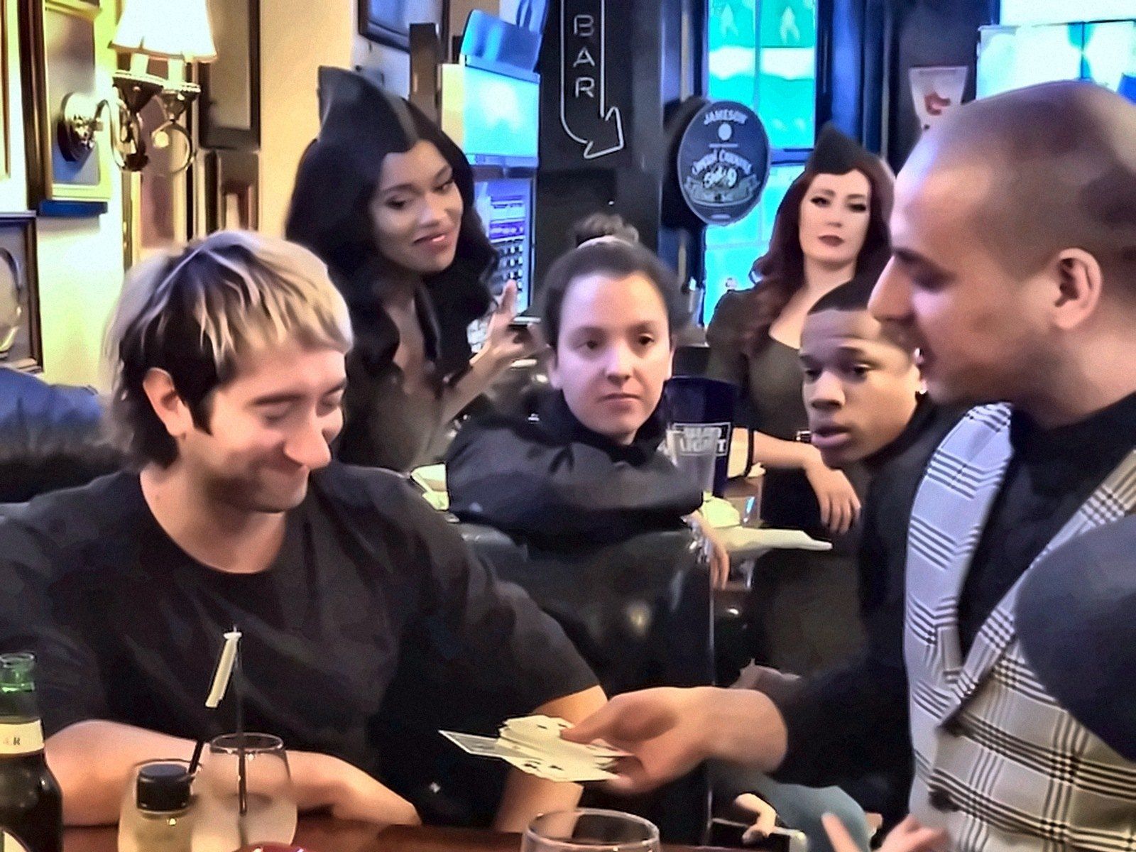 Eric Mina performing close-up card magic for the band Plain White T's